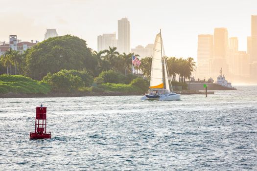 Miami sea habor at golden sunset with american flag, Florida, United States