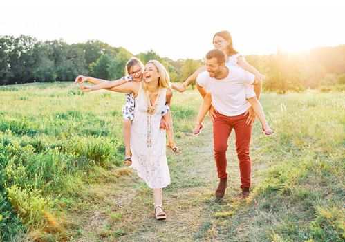 Portrait of a young happy family having fun outdoors