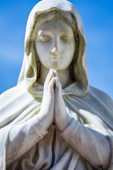 Virgin Mary praying with hands clasped for faith and hope of better days to come