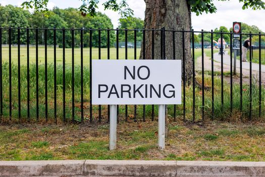 No Parking sign outside of a public park in the UK