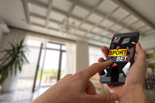 Hand hold a phone with betting online on a screen.
