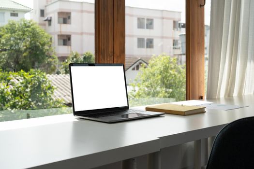 Blank screen computer laptop on working desk