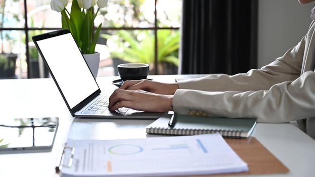 Businesswoman hands typing on laptop, working online or searching information.