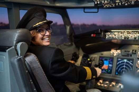 Female pilot on board the aircraft. Caucasian woman in flight simulator