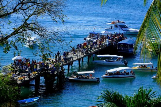 cairu, bahia / brazil - november 14, 2013: tourists are seen during embarkation and disembarkation at the port of the island of Morro de Sao Paulo, in the municipality of Cairu.
