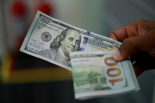 salvador, bahia / brazil - february 11, 2015: Hands hold dollar banknotes in currency exchange.