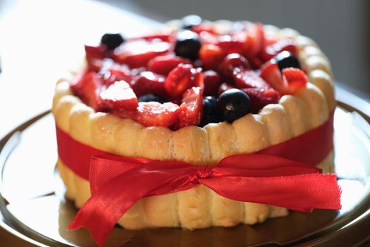 Fresh berry sweet fresh pie with red ribbon. Festive pie concept