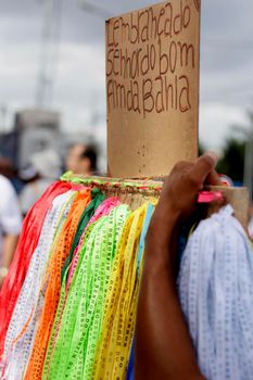 salvador, bahia / brazil - january 15, 2015: person is seen holding tapes of Senhor do Bonfim during religious procession in the church in the city of Salvador.