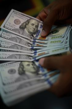 salvador, bahia / brazil - february 11, 2015: Hands hold dollar banknotes in currency exchange.