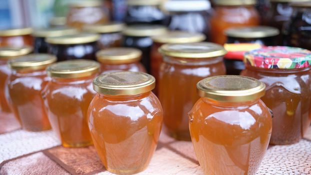 Lot of homemade apple juice in jars closeup. Homemade seams in jars concept