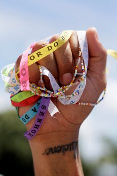 salvador, bahia / brazil - january 15, 2015: hand holds Senhor do Bonfim ribbon during traditional washing of Bonfim church stairs in the city of Salvador.