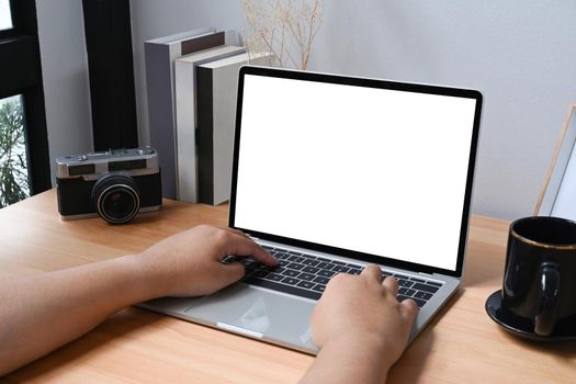 Cropped shot young woman surfing internet with laptop computer.