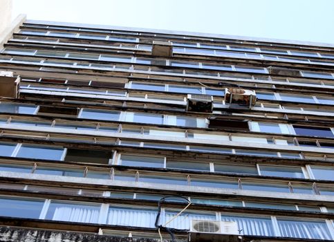 salvador, bahia / brazil - august 13, 2018: air conditioner with rusty brackets and risk of falling are seen installed in a commercial building on Ruy Barbosa Street in downtown Salvador.