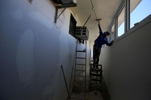salvador, bahia / brazil - august 8, 2018: Wall painter is seen working at home in the city of Salvador.
