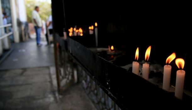 salvador, bahia / brazil - november 8, 2019: Candles are seen burning in the Basilica of Senhor do Bonfim Sanctuary in Salvador.


