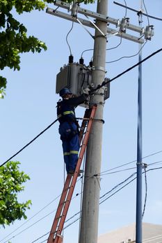 salvador, bahia / brazil -  february 28, 2019: Electrician makes repairs to the power grid during the Carnival period in the city of Salvador.