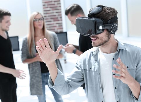 Business team testing virtual reality headset in office meeting.