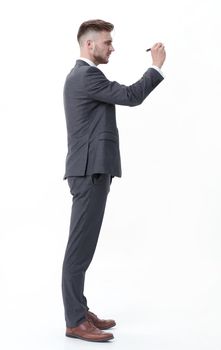 side view.businessman writing on an invisible Board.photo in full growth
