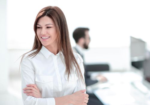 smiling business woman on the background of the workplace. photo with copy space