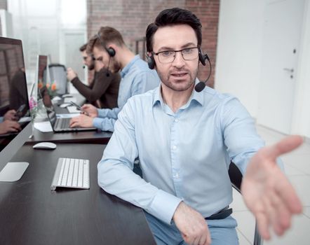 modern businessman in a headset reaching out for a handshake. business concept