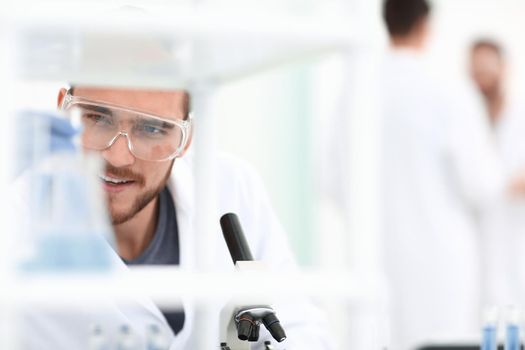 closeup.male chemist on blurred background laboratory .people and science.