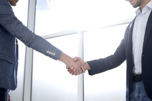 business people shaking hands in a bright office.concept of cooperation