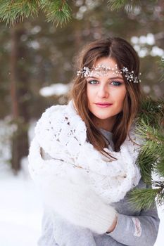Beautiful bride in a white dress with a bouquet in a snow-covered winter forest. Portrait of the bride in nature.Beautiful bride in a white dress with a bouquet in a snow-covered winter forest. Portrait of the bride in nature.