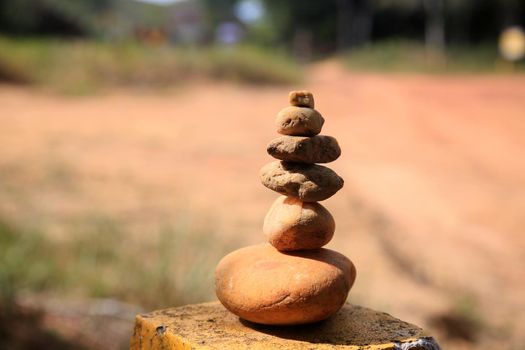 conde, bahia, brazil - january 9, 2022: Stacked pyramid of round stones seen on a road in the city of Conde.