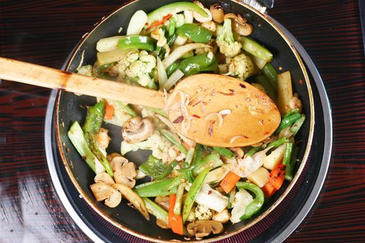 cooking fresh vegetables in a pan, top view ,