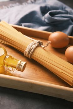 Yellow long spaghetti egg and oil on table ,