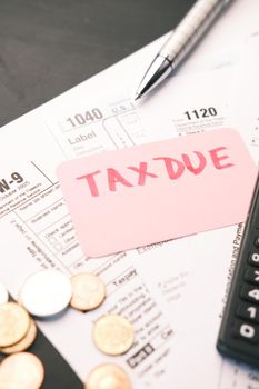 Tax return form and hand written tax due on table .