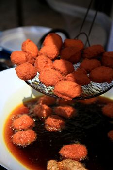 salvador, bahia / brazil - januuary 1, 2020: Acarejes are seen frying in dende azure in the city of Salvador.