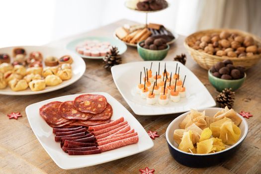 Slices of chorizo, salami and beef on buffet table.