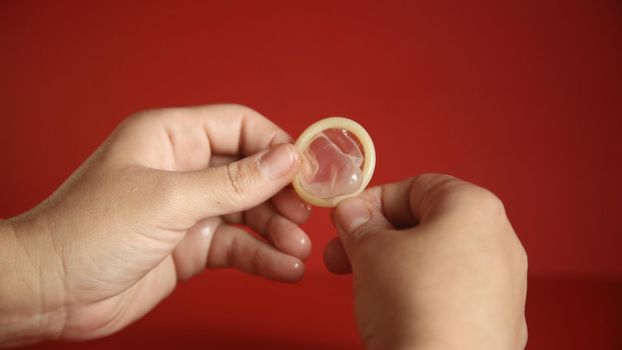 salvador, bahia, brazil - november 14, 2021: person securing a male condom from the city of Salvador. 