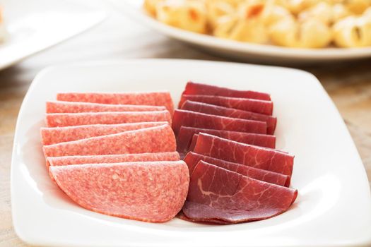 Party appetizer platter of salami and besaola italian meats.