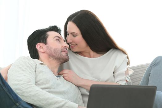 man with his girlfriend chatting on laptop at home indoor.photo with copy space