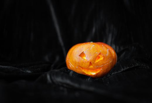 October 31, Halloween - Old Jack-o-Lantern on a black background. Place for an inscription