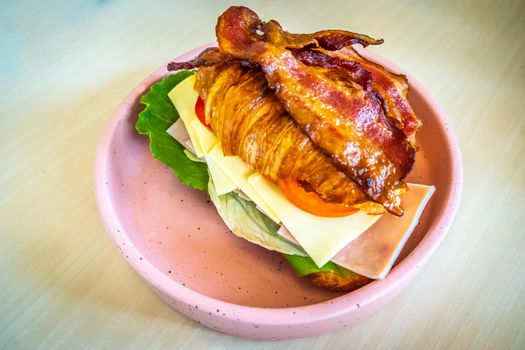 Turkey sandwich on a croissant with swiss cheese ham vegetable healthy breakfast in morning food