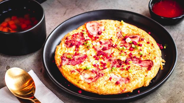 Spanish omelet Frittata made of eggs potato bacon paprika parsley green peas onion cheese for delicious food.
