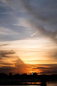 Giant dark cloud. Storm Clouds orange sky at Sunset nature landscape.