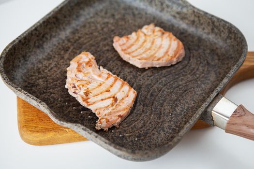 Grilled fresh tuna steak in a pan, top view. Delicious and healthy food