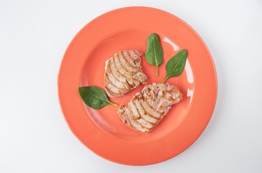 Close-up of a juicy delicious grilled tuna steak on a bright plate. Delicious and healthy food, proper nutrition