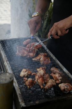 conde, bahia, brasil - january 8, 2022: person making barbecue at coal prasa in Conde city.
