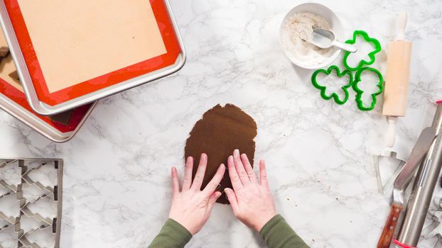 Flat lay. Step by step. Cutting out shapes with Christmas cookies cutter from gingerbread cookie dough.