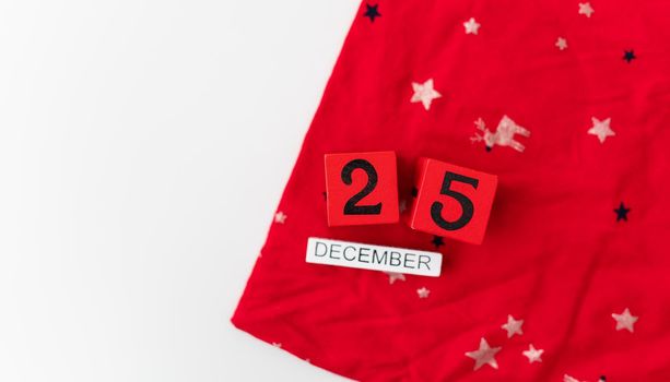 December 25 is lined with red cubes along with December lettering on a red Christmas background. Christmas Eve