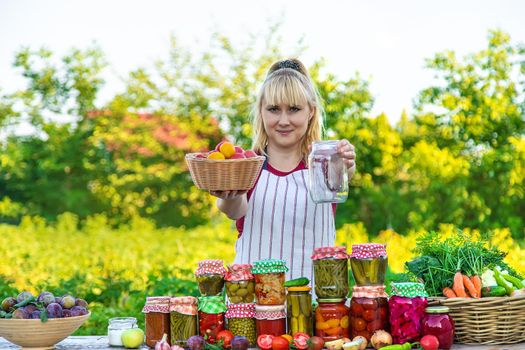 Woman with jar preserved vegetables for winter. Selective focus. Food.