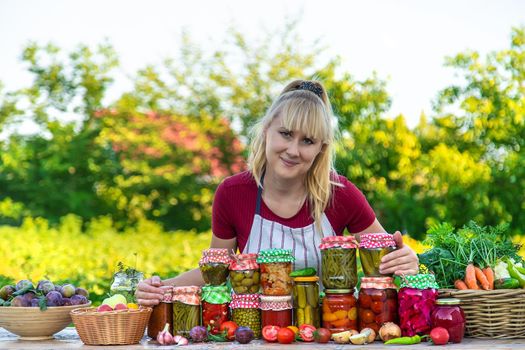 Woman with jar preserved vegetables for winter. Selective focus. Food.