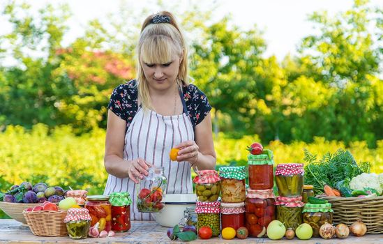 Woman with jar preserved vegetables for winter. Selective focus. Food.