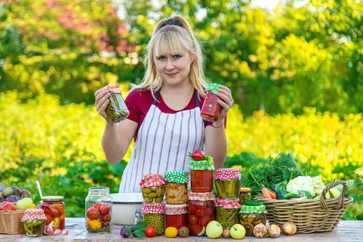 Woman with jar preserved vegetables for winter. Selective focus. Food.