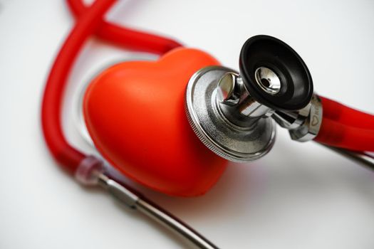 Stethoscope and red heart on white background, heart health, health insurance concept.